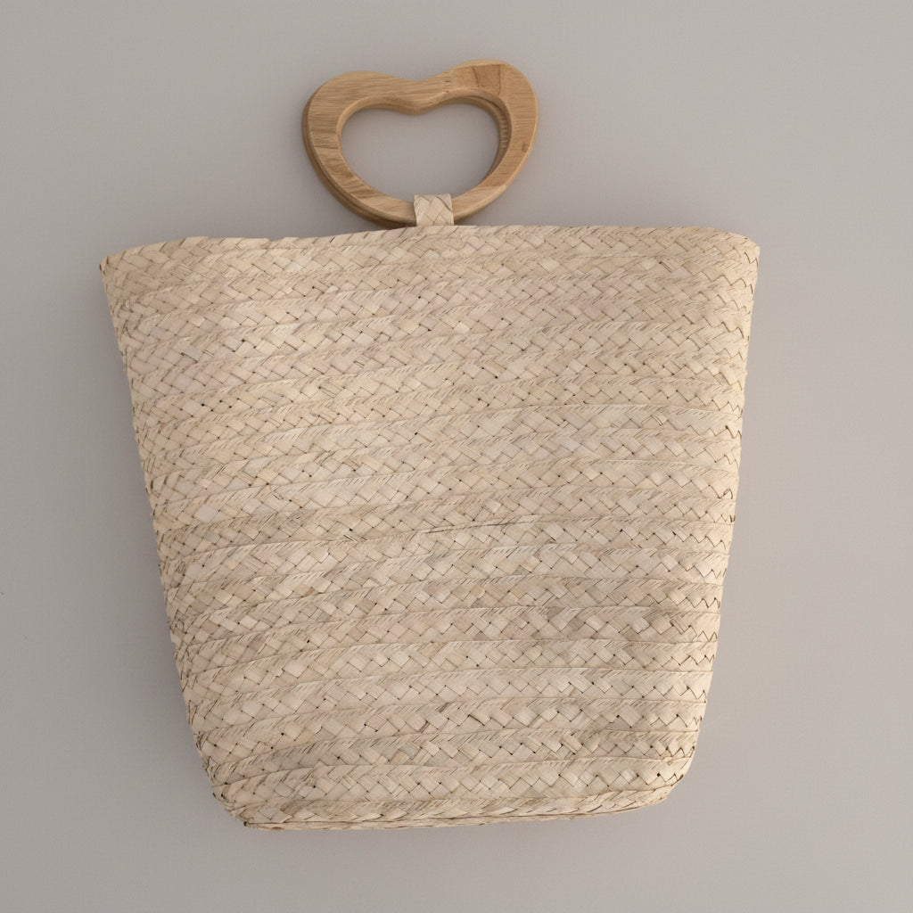 Palm bucket bag with wooden heart handle by Khoos
