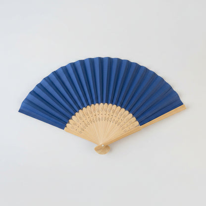 A traditional folding hand fan with a dark blue fabric upper section and a natural light wood lower section, shown fully opened against a plain light gray background.