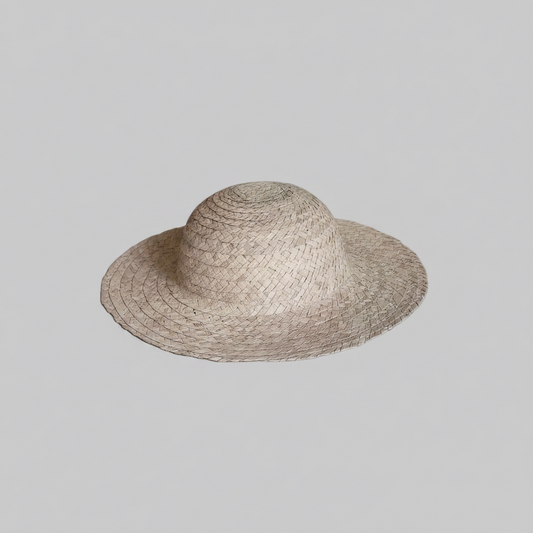 A natural straw sun hat with a wide brim and a conical crown, shown against a solid gray background.