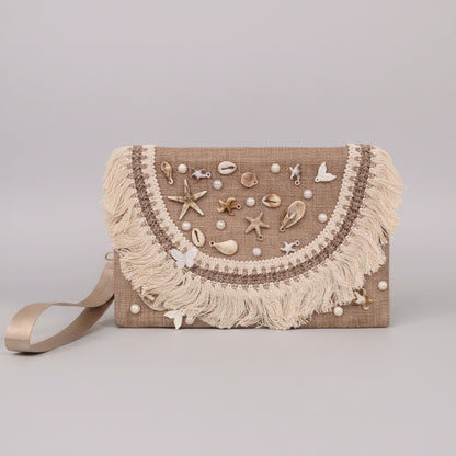 Handwoven seashell-embroidered clutch with cotton fringe by Khoos