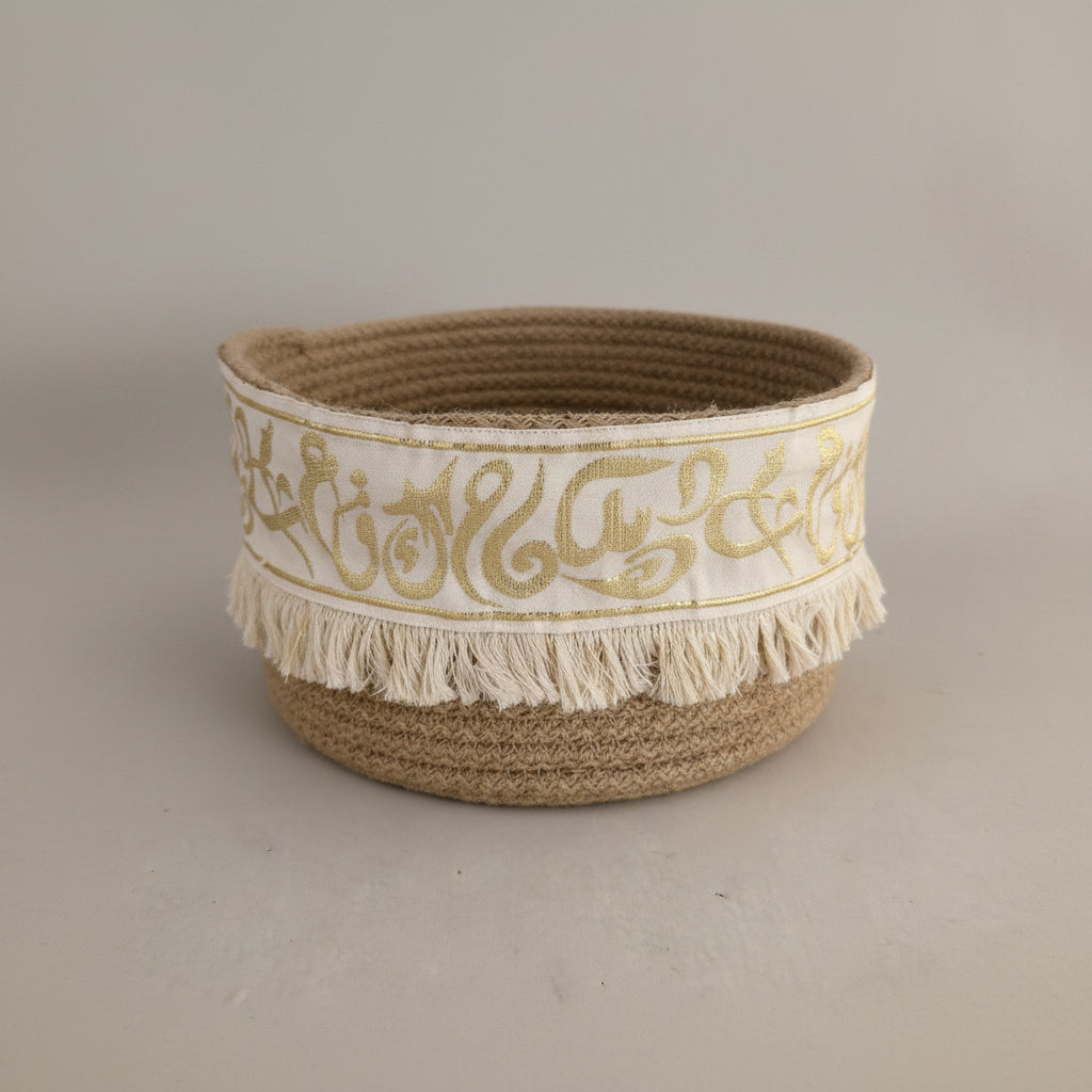 Coiled basket with gold Arabic calligraphy and fringe by Khoos