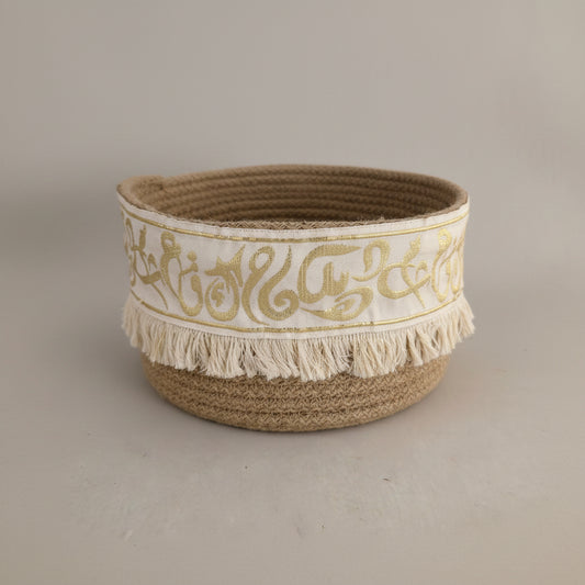 Coiled basket with gold Arabic calligraphy and fringe by Khoos