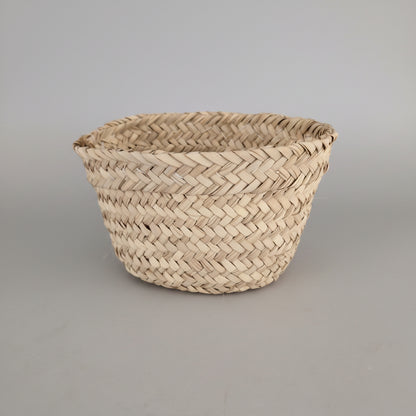 Conical woven palm basket planter by Khoos