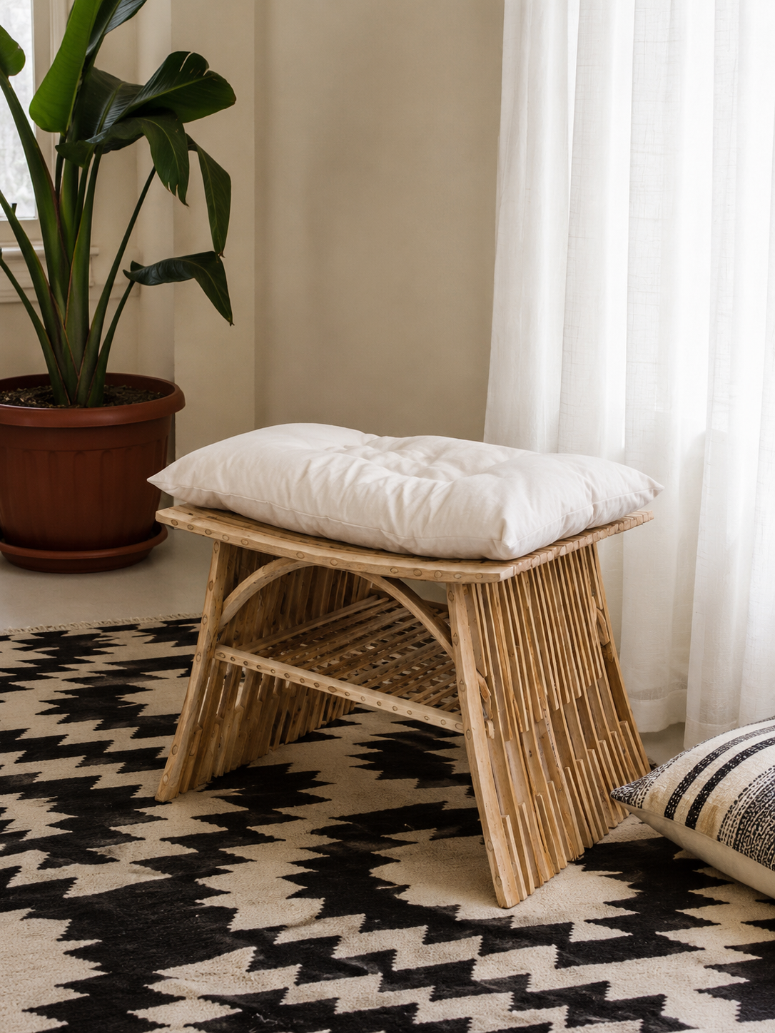 Al-Nakhaal palm stool with ivory cushion on a patterned rug, side view - Khoos