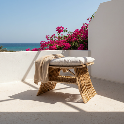 Al-Nakhaal palm stool with a beach towel over the cushion on a whitewashed Sahel terrace by the sea - Khoos