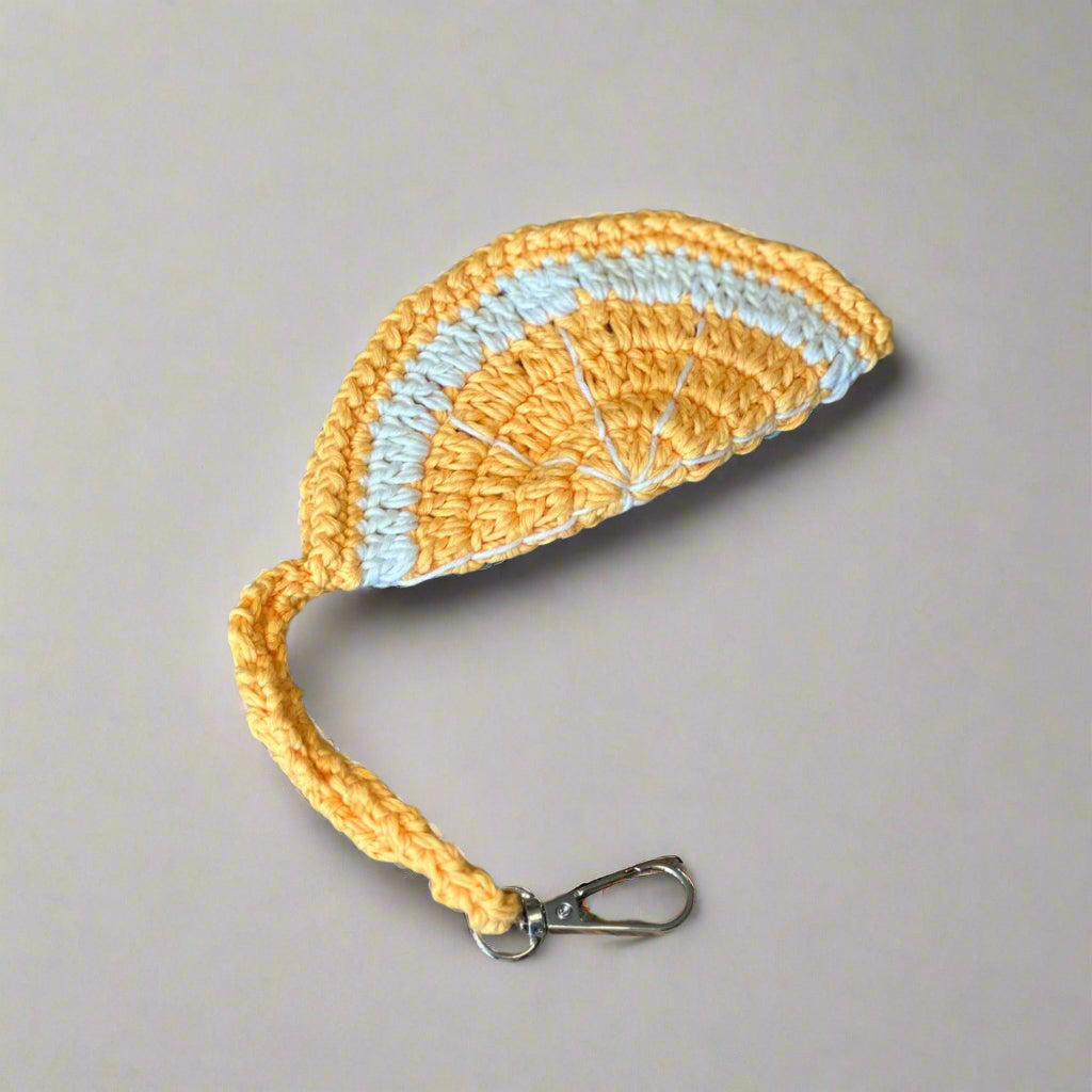 Tangerine orange hand-crocheted sunglasses case with a cream centre, wrist strap and clip, 14 cm — Khoos