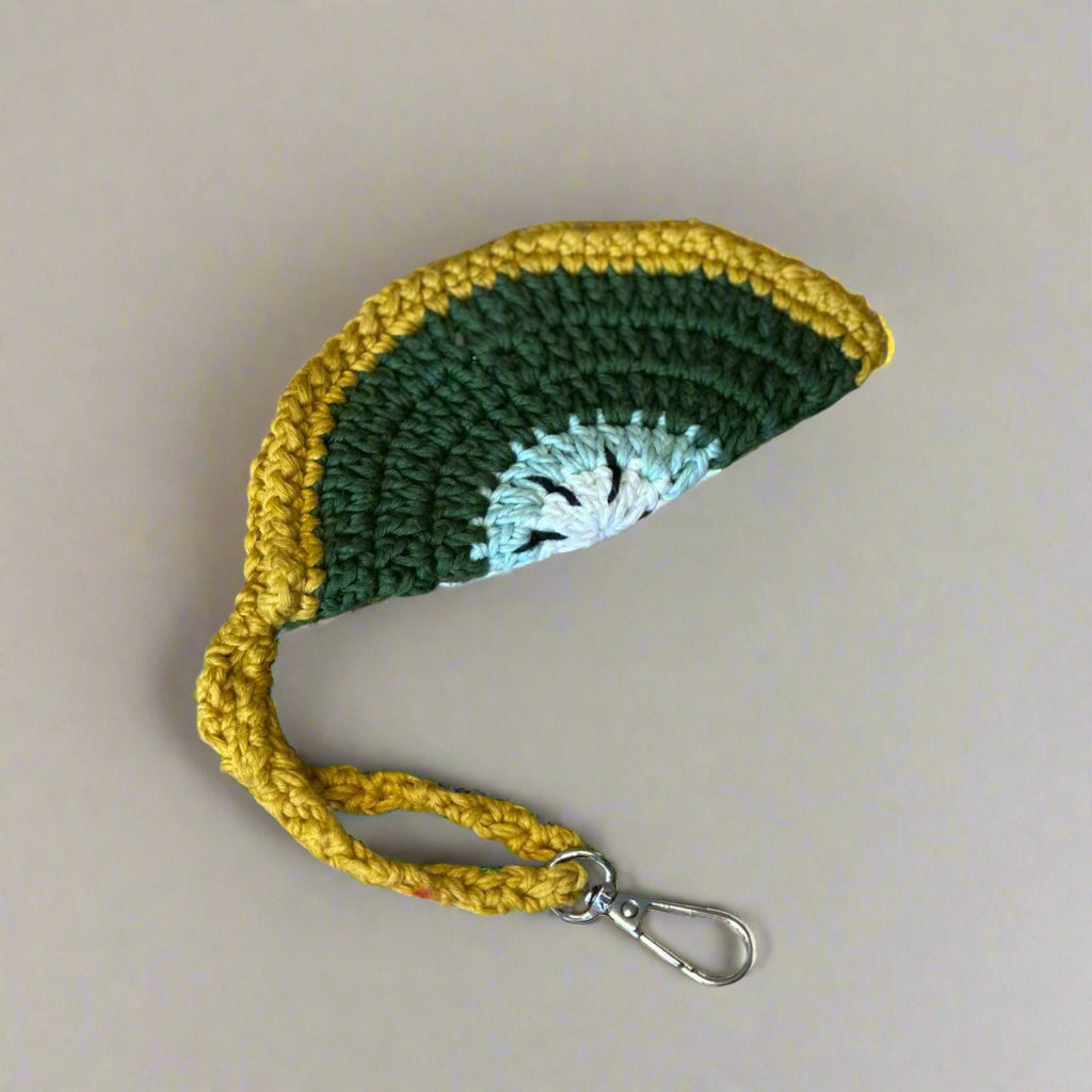 Mustard hand-crocheted sunglasses case with olive and cream banding, wrist strap and clip, 14 cm — Khoos