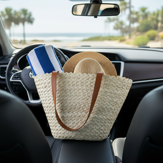 Eco-Chic palm tote packed with a towel and straw hat on a car seat, coastal road ahead — Khoos