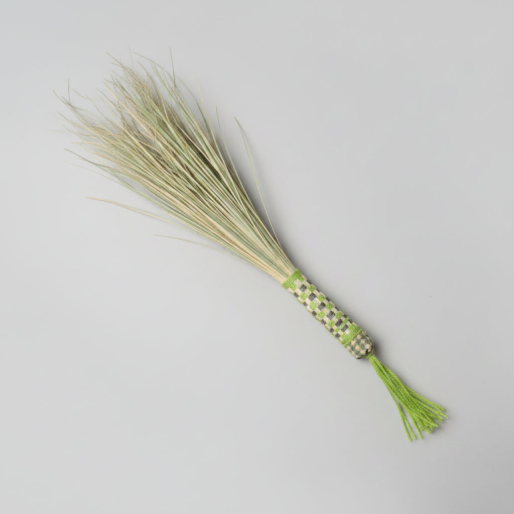Lemonada manasha palm hand broom with green-and-white gingham handle and bright green tassel, on a plain studio backdrop — Khoos